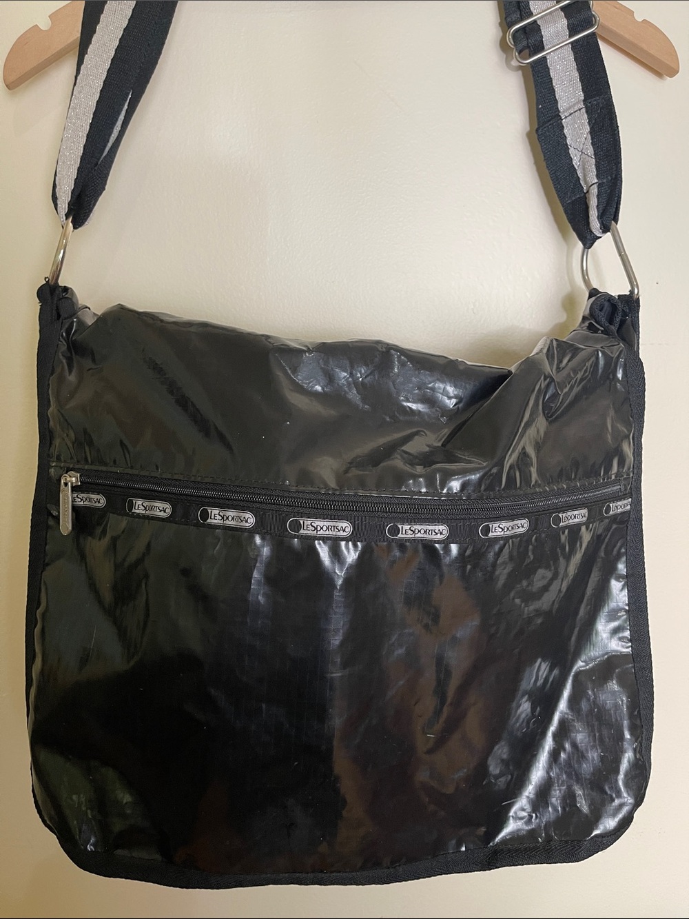 LeSportsac crossbody hobo bag in a sleek, liquid patent